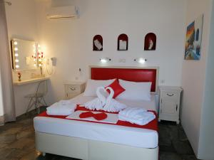 a bedroom with a bed with towels on it at Eleni Dream Village in Parikia