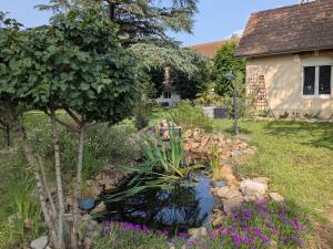 a pond in the yard of a house at Appartement dans haras in Saint-André-le-Puy