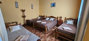 a room with two beds in a room with at Cabaña KUYAY in Purmamarca