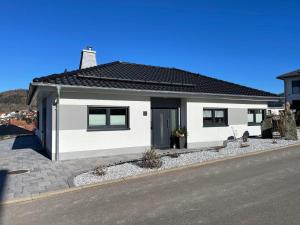 a white house on the side of a street at Ferienhaus Marina in Floh