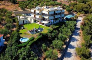 an aerial view of a large house with a yard at Meltemi Rooms and Apartments in Finikounta