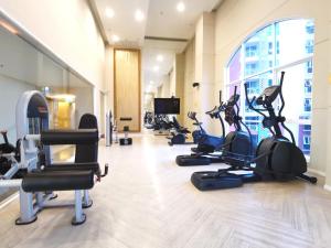 a gym with treadmills and elliptical machines at Caribbean Water Park Hotel in Pattaya South