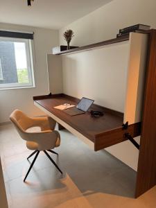 a desk with a laptop and a chair in a room at Seaview234 in Middelkerke