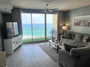 a living room with a view of the ocean at Beach, Sand, Sun & Pool 2BR 2BA Condo in Panama City Beach