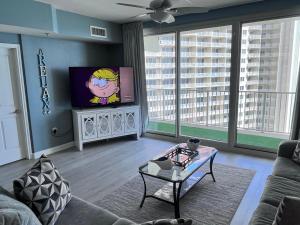 a living room with a couch and a flat screen tv at Beach, Sand, Sun & Pool 2BR 2BA Condo in Panama City Beach