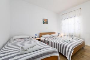 Postel nebo postele na pokoji v ubytování Apartments Snjezana by El-Pi Tours