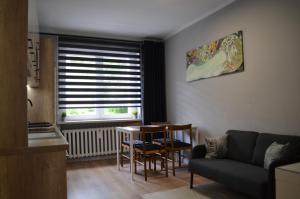a living room with a couch and a table at Apartment Reden Park - Free Parking - easy check-in in Chorzów