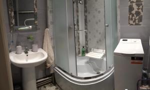a small bathroom with a sink and a shower at Cozy apartment near the sea in Zvejniekciems +13 photos
