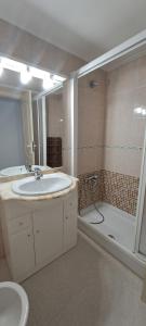a bathroom with a sink and a shower at CARIBE Apartamento in Oropesa del Mar +28 photos