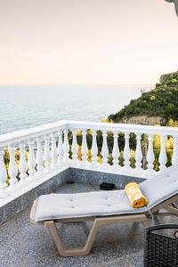 a balcony with a white railing and the ocean at Villa Mae in Elaiokhórion