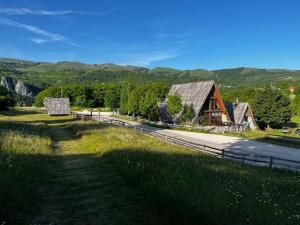 a barn on the side of a road at Jatak Cabins and Camping in Petnjica