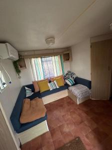 a living room with a blue couch and a window at Villa Paquita in Vallejas