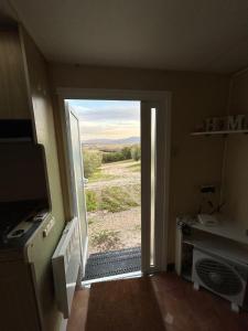 a door to a room with a view of a field at Villa Paquita in Vallejas