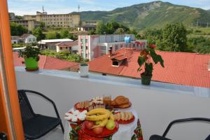 a plate of food on a table on a balcony at Apartament Cela in Çorovodë