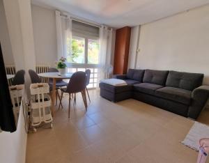 a living room with a couch and a table at Calafats in Lloret de Mar