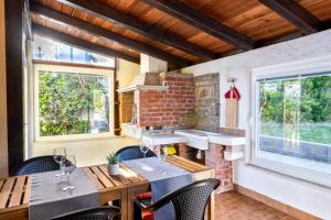 a patio with tables and chairs and a brick wall at Borea Strunjan in Portorož