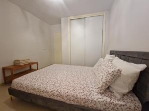 a bedroom with a bed with pillows on it at Calafats in Lloret de Mar