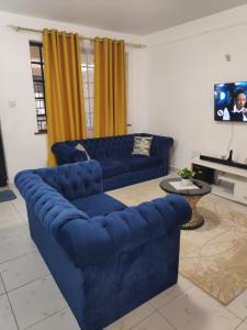 TV a/nebo společenská místnost v ubytování M & L Homes E7