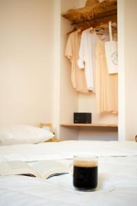 an open book sitting on a bed next to a closet at Memories by the Sea - Margarida do Mar in Costa da Caparica