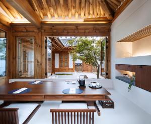 a dining room with a wooden table and chairs at Hyowudang in Gyeongju