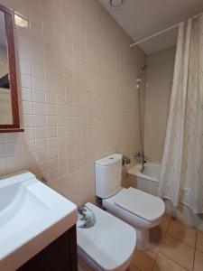 a bathroom with a white toilet and a sink at Apartamento abuhardillado y espacioso Aüt 3 in Pla de l'Ermita +27 photos
