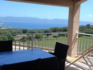 a blue table and chairs on a balcony with a view at A CASA DI PAULINA in Serra-di-Ferro +4 photos