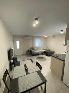 a living room with a table and chairs and a couch at Alion houses in Prinos +11 photos