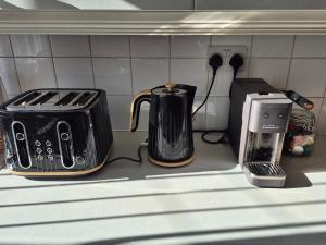 two toasters and a toaster on a kitchen counter at Tailte Trá in Carnlough