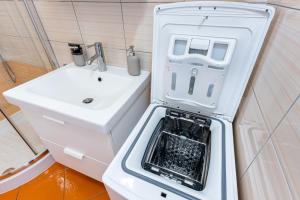 a small white refrigerator next to a sink at Borea Strunjan in Portorož +54 photos