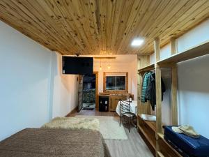 a bedroom with a bed and a tv on the ceiling at Pousada Saint Claire in Santo Antônio do Pinhal