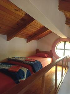 a bedroom with two beds in a attic at Cabaña la candela in Bernal