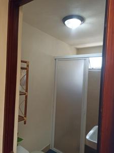 a bathroom with a shower and a sink at Cabaña la candela in Bernal