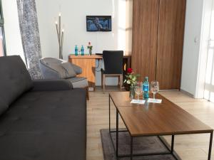 a living room with a couch and a table at Pension Weserblick in Bremen +5 photos