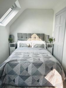 a bedroom with a large bed and two night stands at Connemara Ocean Escape in Galway