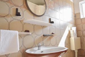 a bathroom with a sink and a mirror at Rosemary Apartment in Promajna