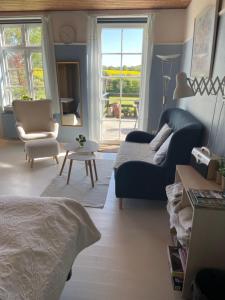a living room with a couch and a chair at Skovgården in Hillerød