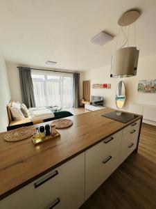 a kitchen with a wooden counter top in a room at Sunny apartment BRNO in Medlánky