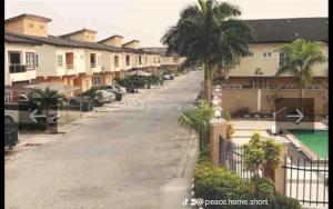 a street with houses and a fence and palm trees at Short Let Apartments in Lagos Business School Lekki Ajah in Lekki