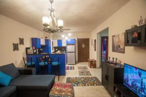 a living room with a couch and a kitchen at Chalet in Sahel Mountain view Diplo in Ras Elhekma