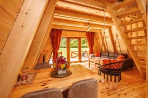 a dining room and living room in a log cabin at Silence House in Šavnik