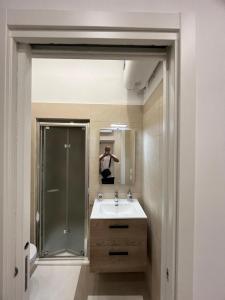 a man taking a picture of a bathroom with a sink at CasaVacanzeCassanelli in Bisceglie +6 photos