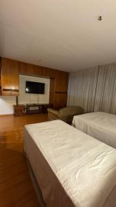 a hotel room with two beds and a flat screen tv at KUBITSCHEK - JK APART Hotel in Brasília +55 photos