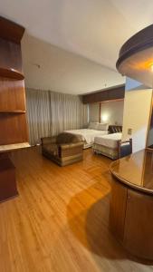a large room with two beds and a couch at KUBITSCHEK - JK APART Hotel in Brasília
