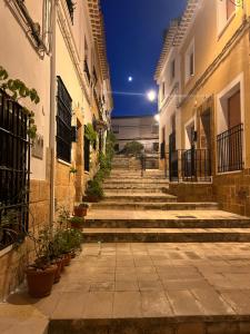 an alley with stairs in a city at night at La casita del Cerro in Chinchilla de Monte Aragón