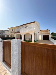 a house with a wooden fence in front of it at El Balcón de Villablancas in La Manga del Mar Menor