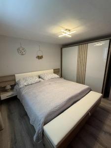 a bedroom with a large bed with a white comforter at Blue Sky Apartment in Bled +285 photos