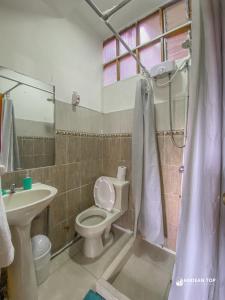 a bathroom with a toilet and a sink at Panoramic City View Terrace House , 5 Bedrooms in Cusco