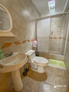 a bathroom with a toilet and a sink at Panoramic City View Terrace House , 5 Bedrooms in Cusco