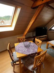 a dining room with a table and chairs and a window at Apartment Mosel-Götterlay in Bruttig-Fankel