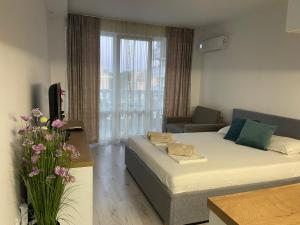 a living room with a bed and a couch at Студио Симона 2 - първа линия море in Lozenets